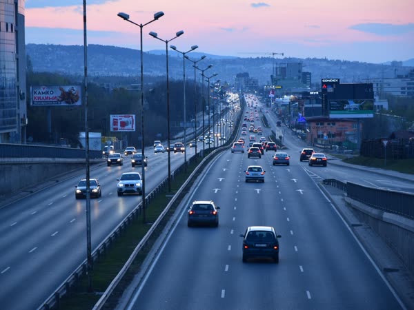 Reference photo: a multi-lane highway with traffic at dusk
